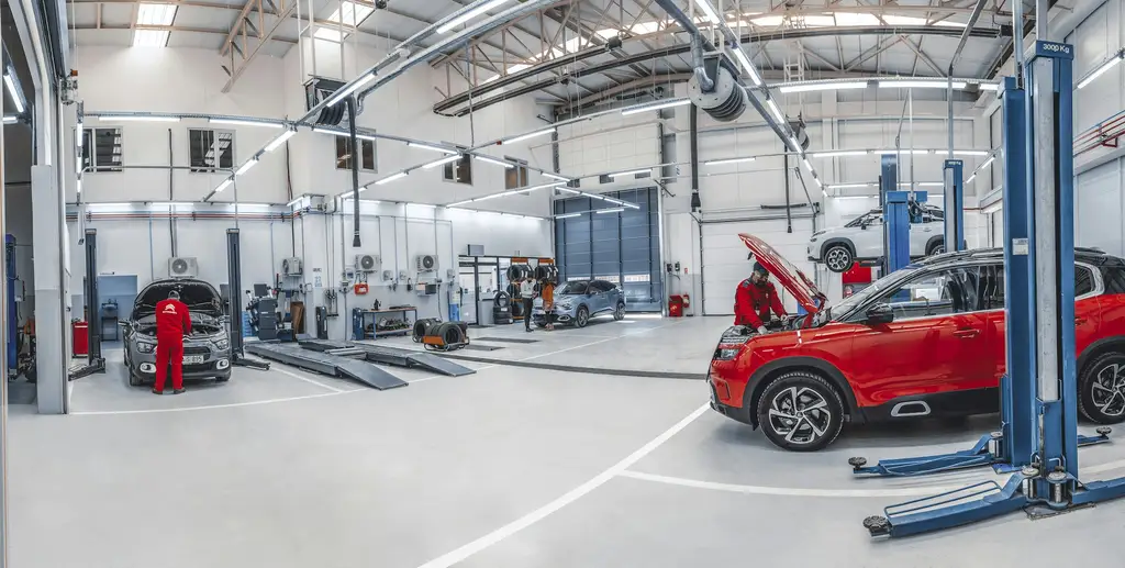 Bright vehicle workshop with cars on lifts at Billingshurst MOT & Service Centre